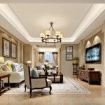 Traditional living room with beige tones, tufted sofa, classic chandelier, and patterned rug.