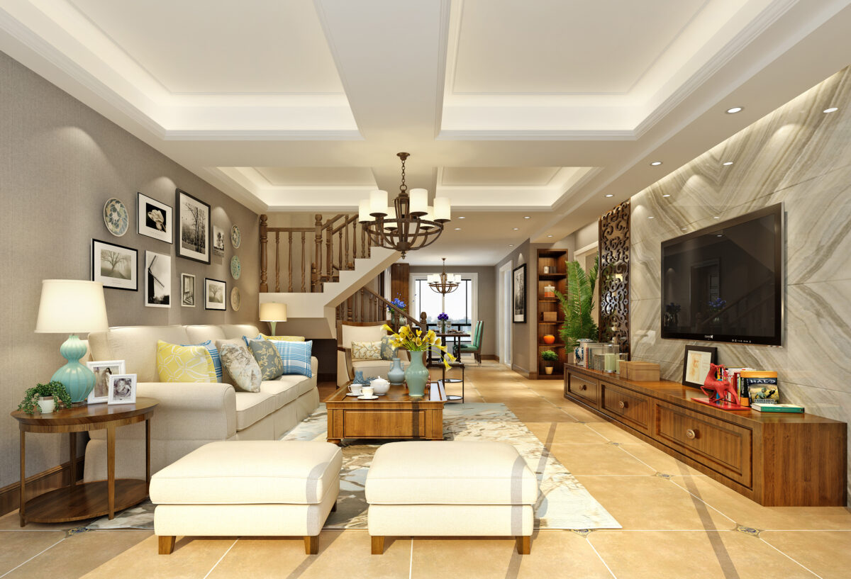 Contemporary living room with open staircase, beige sofa, patterned cushions, rustic chandelier, and marble TV wall.