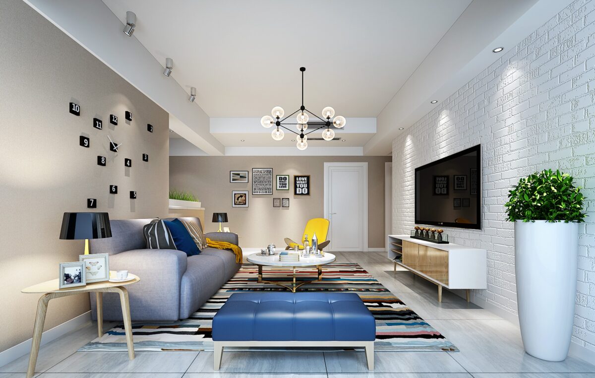 Modern living room featuring a blue tufted ottoman, a yellow accent chair, a colorful striped rug, and a textured white brick wall.