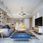 Modern living room featuring a blue tufted ottoman, a yellow accent chair, a colorful striped rug, and a textured white brick wall.