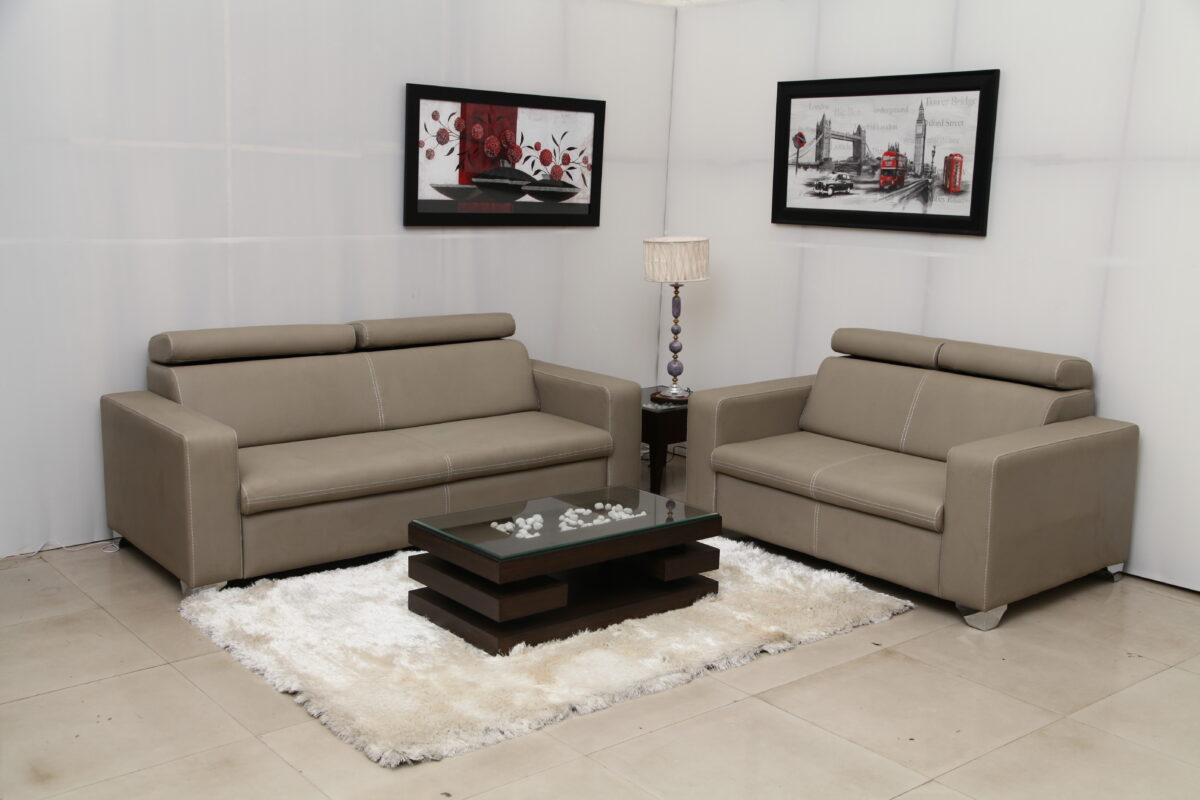 Modern beige leather sofa set with comfortable headrests, ideal for contemporary living rooms.