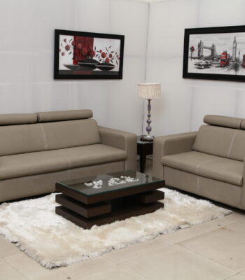Modern beige leather sofa set with comfortable headrests, ideal for contemporary living rooms.