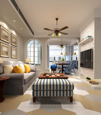 Living and dining room with beige walls, hexagonal flooring, a gray sofa with yellow cushions, and wooden furniture.