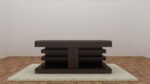 Wooden center table with artistic carved design under a tempered glass top, featuring a tiered structure on a plush rug