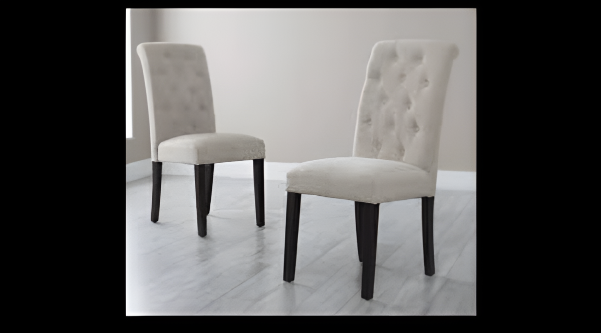 Set of two elegant button-tufted dining chairs with soft upholstery and solid wooden legs in a modern room.