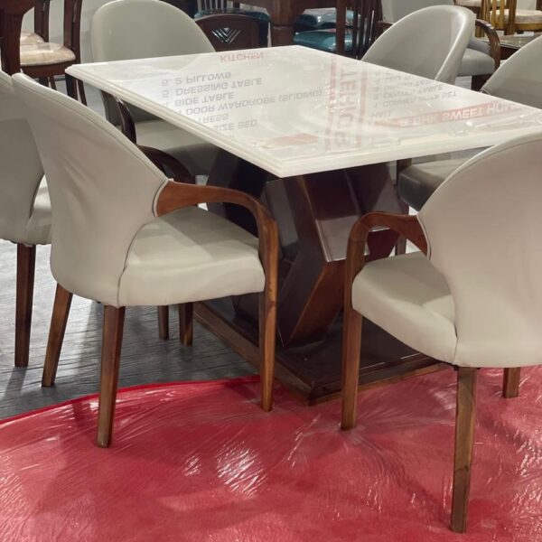 Elegant dining set with a marble-finished table and six cushioned chairs in a modern dining space.