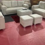 Modern 3+2 sofa set with white leatherette upholstery and matching ottomans, ideal for contemporary living rooms.