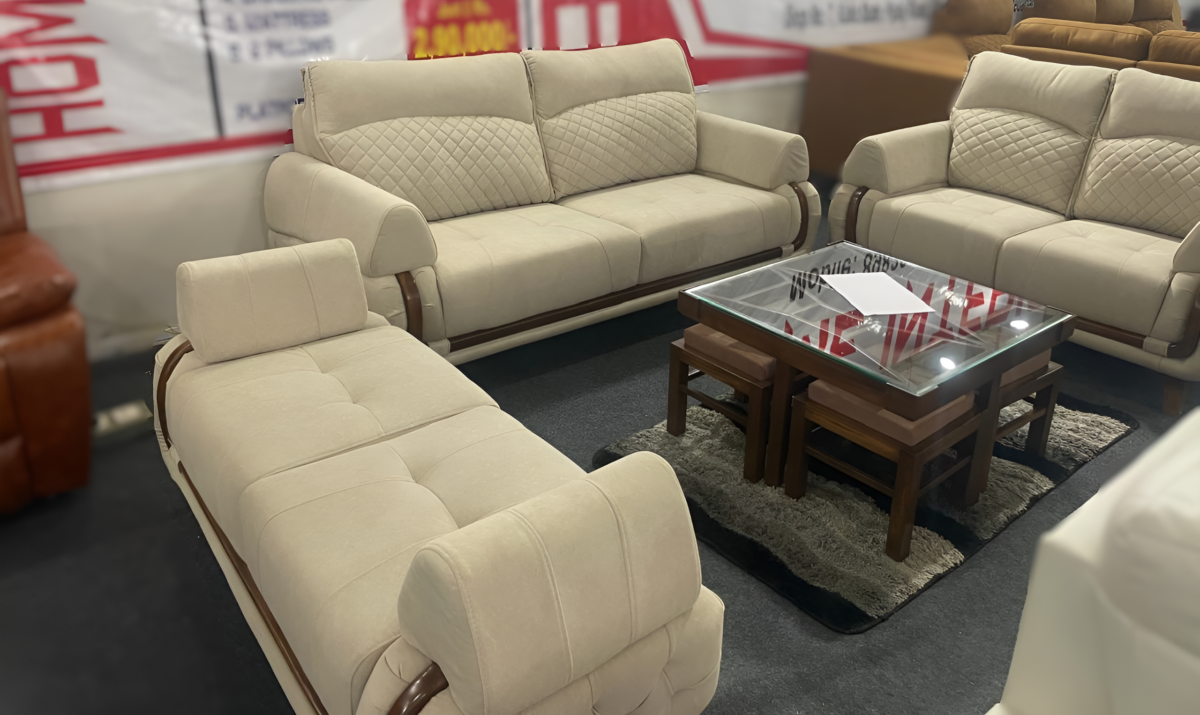 Bangdi 3+2 sofa set with quilted beige upholstery, wooden accents, and a matching puffy in a contemporary living room.