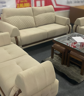 Bangdi 3+2 sofa set with quilted beige upholstery, wooden accents, and a matching puffy in a contemporary living room.