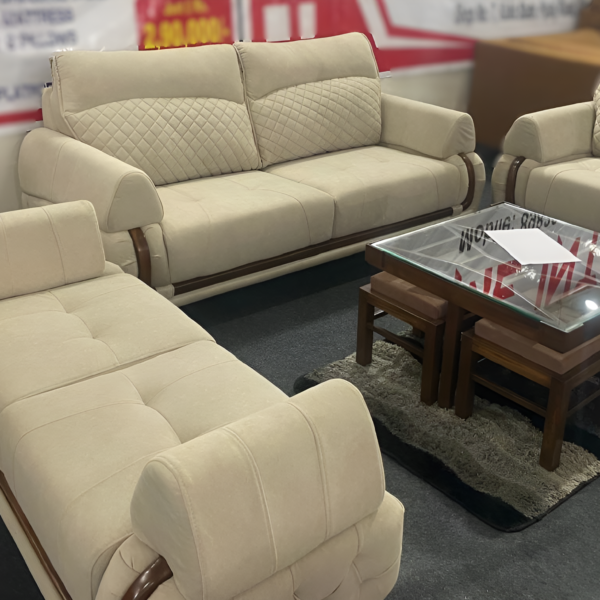 Bangdi 3+2 sofa set with quilted beige upholstery, wooden accents, and a matching puffy in a contemporary living room.